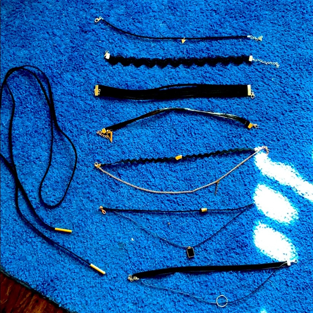 7 black chokers and one Bolo cord